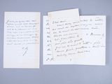 two papers with handwriting on them sitting on top of a table