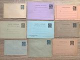 six envelopes of different colors and sizes on a wooden table