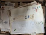 many mails in a box that are sitting on the floor