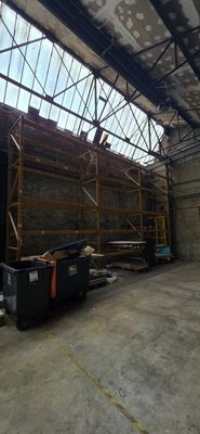 a large warehouse with a lot of scaffolding on the roof