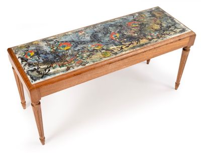 a small table with a painting on the top of it