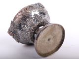 a silver vase with a lid sitting on a table