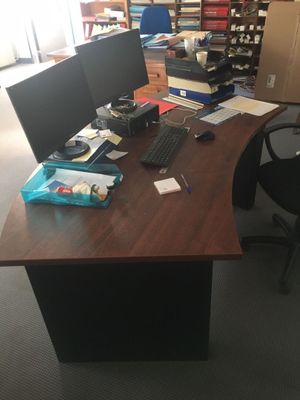 a desk with two monitors and a keyboard on it