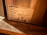 a picture of a stainless steel dishwasher sitting on a wooden table