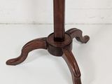 an old wooden table with a marble top and a wooden base