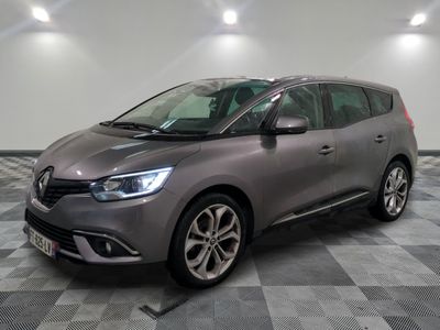a grey car parked in a room with a checkered floor