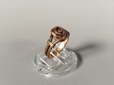 a close up of a ring on top of a clear plate
