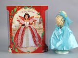 a doll that is standing next to a box