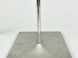 a close up of a metal plate with a metal pole on top of it