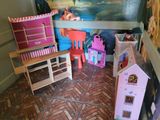 a room with a doll house and a doll house on the floor