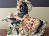 a figurine of a man riding a horse on a table