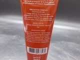 a close up of a tube of cream on a table