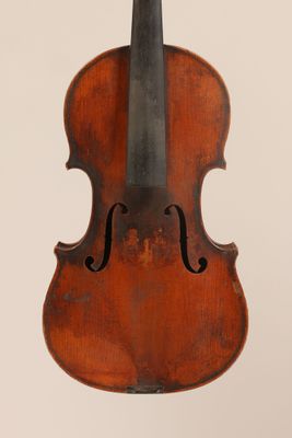 an old violin with a bow hanging from the back