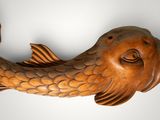 a wooden sculpture of a fish that is hanging on the wall