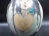 a vase that has a picture of a woman on it