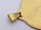 brass plate with a bow on it on a white surface