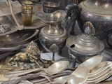 a lot of silver and silverware on a table