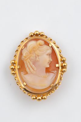 une broche-camaïeu en or et coquillage représentant une femme