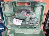 a green tool box with a hammer inside of it