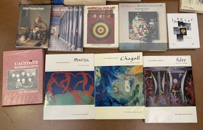 several books are sitting on a table next to a cup of coffee