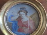 painting of a woman with a bird in her hand in a gold frame