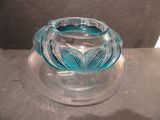 a glass vase that is sitting on a glass plate