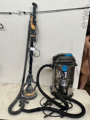 two vacuums and a canister sitting on a table