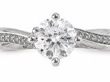 a close up view of a diamond engagement ring with a twist band