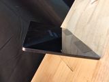 a cell phone sitting on top of a wooden table