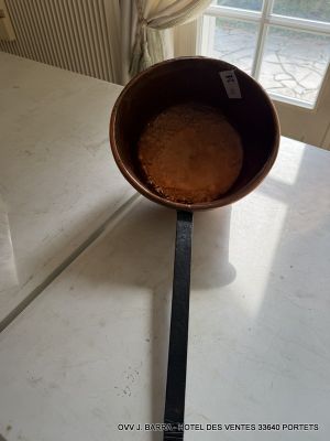 a pan that is sitting on a counter with a spoon in it