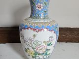 a vase that is sitting on a shelf in a room