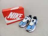 pair of blue and white running shoes next to a box of red and white shoes