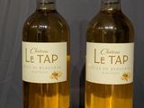 two bottles of wine that are sitting on a table