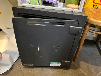 a black oven sitting on the floor next to a table