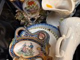 a pile of porcelain items that are sitting on top of a table