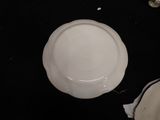 a white plate sitting on top of a black table