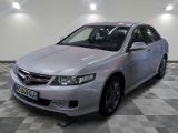 the silver honda accord is parked in a clean room