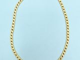 a gold chain necklace on a blue background