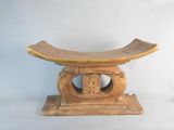 a small wooden bench with a carved design on it