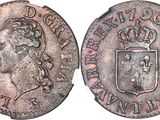 a silver coin with a crown on top of it