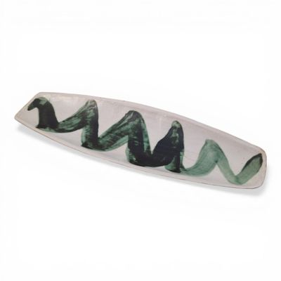 a white plate with a green wave design on it