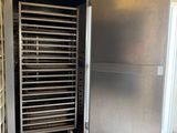 a stainless steel oven with a door open in a kitchen