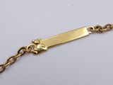 a close up of a gold plated bracelet on a white surface