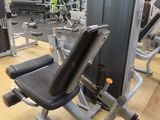 a gym room with a row of machines in it