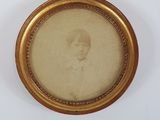 an old picture of a young boy in a gold frame on a white background