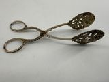 pair of antique silver scissors on white surface with white background