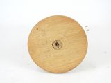 a small wooden object with a hole in the middle of it