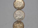three different coins sitting on top of each other on a table