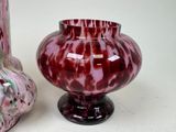 two vases sitting next to each other on a table