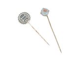 pair of silver and opalite broochers with a blue stone in the center